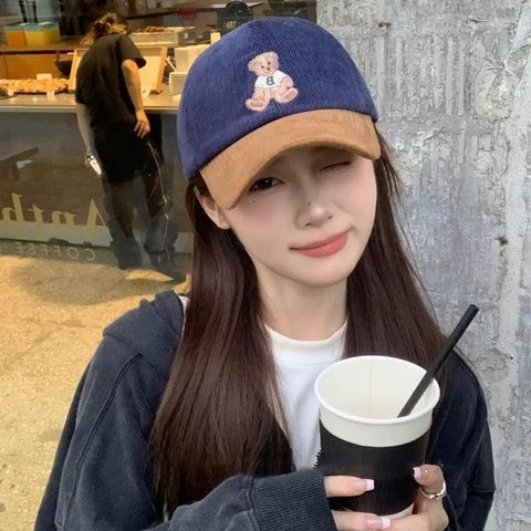 Navy corduroy cap with a small bear embroidered on the front