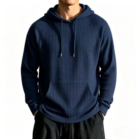 Navy waffle-texture hoodie worn with dark trousers