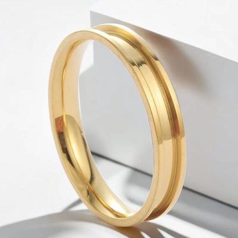 Gold grooved steel band on a white stand