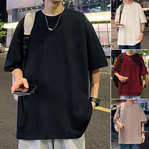Oversized black cotton T-shirt worn outdoors